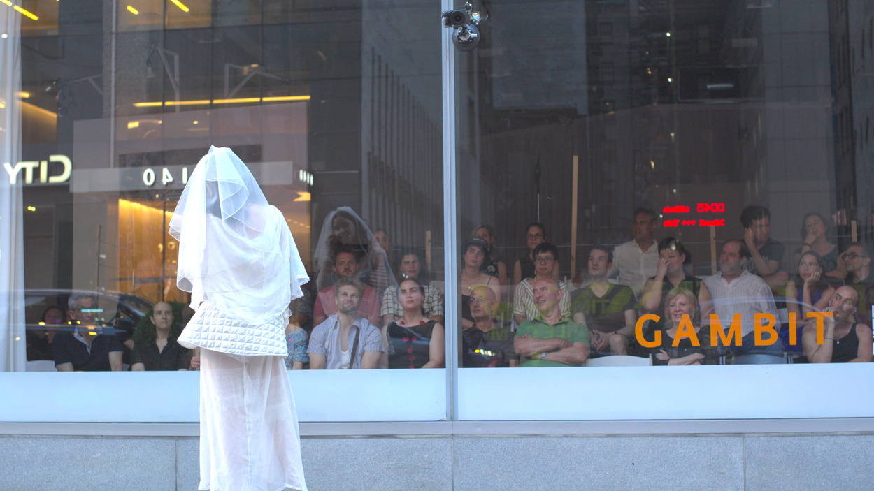 The audience watching a New York street through a storefront window